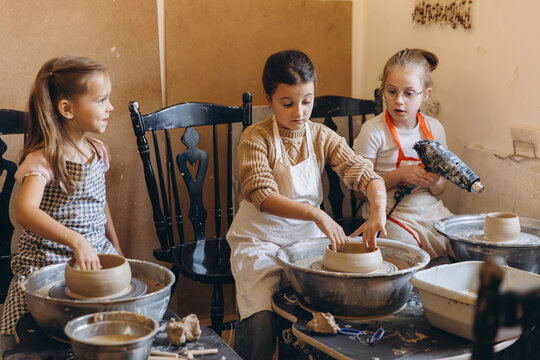 Children learning pottery craft in workshop