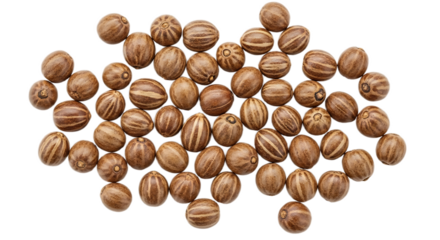 A collection of many brown striped seeds scattered on a black background in a studio shot