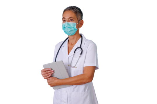 Senior female doctor wearing protective medical mask and uniform, holding a digital tablet, providing healthcare services