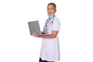 Senior woman doctor wearing white scrubs and stethoscope, holding a laptop, working on digital healthcare data with transparent background