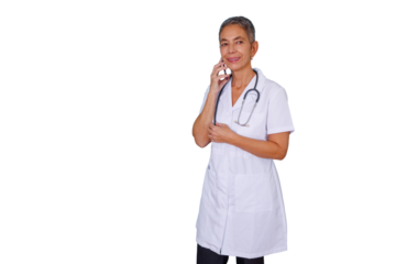 Senior female doctor wearing a lab coat and stethoscope, engaged in a phone call, smiling while offering online medical advice