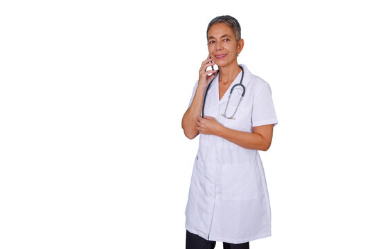 Senior female doctor wearing a lab coat and stethoscope, engaged in a phone call, smiling while offering online medical advice