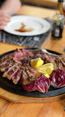 Close up of sliced tagliata beef steak served on a plate in fine dining restaurant