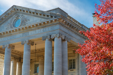 Classical columns and bright red leaves. Washington, D.C. architecture in autumn