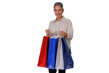 Senior woman smiling, enjoying shopping and carrying multiple retail bags, presenting a concept of consumerism
