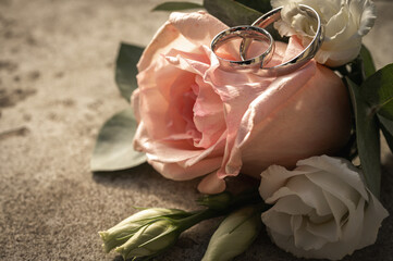 Beautiful bridal bouquet with pink roses, white eustoma and eucalyptus on a stone railing. Wedding floral decoration close-up with copy space on blurred background