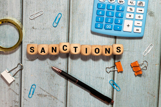 sanction word written on wood block. sanction text on table, concept