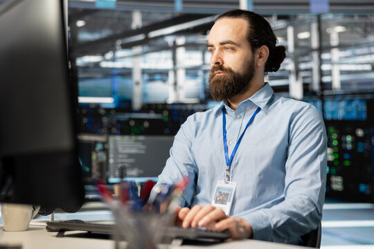 Employee working in server hub, managing large datasets for artificial intelligence training. Engineer overseeing infrastructure running neural networks and analytics tasks in data center