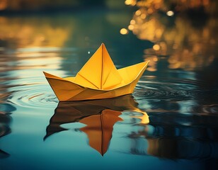 yellow paper boat floats on still water