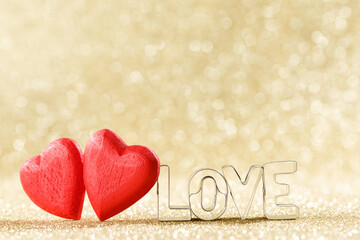 wooden valentine hearts on bokeh background