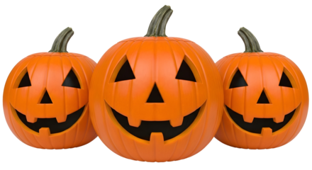 Three glowing carved orange pumpkins with cheerful faces isolated on transparent PNG background