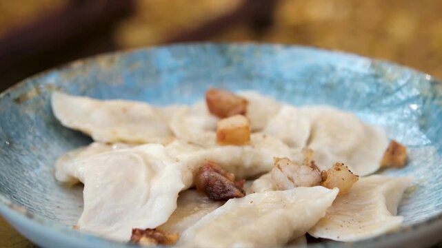 Japanese gedza on wooden steamer close-up. Fried dumplings with meat. Steaming Technique. Cooking at cafe, restaurant. Homemade. Delivery. High quality 4k footage