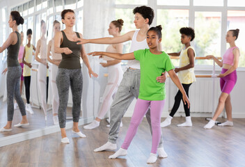 Fototapeta premium Couple teen boy and girl perform paired ballet dance in studio