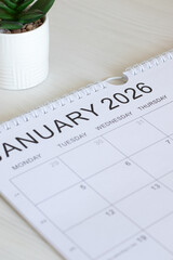 January 2026 new year calendar with a plant. Close-up. Annual goals, aspirations, business growth and planning concept.