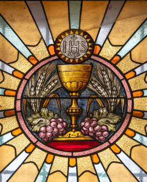 Stained glass window (19th century)  depicting the IHS Christogram.