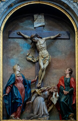 Wood sculpture (19th century) of Jesus Christ crucified on the cross represented with Mary, Mary Magdalene and Saint John. j