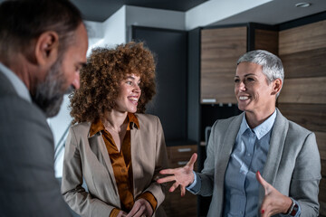 Business colleagues having a cheerful conversation during office meeting