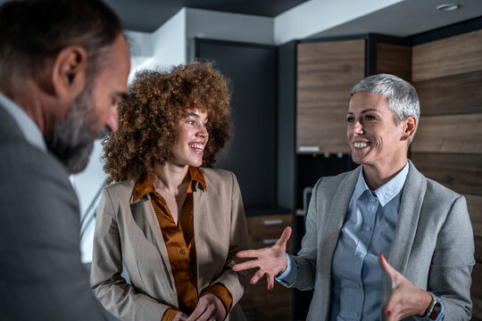 Business colleagues having a cheerful conversation during office meeting