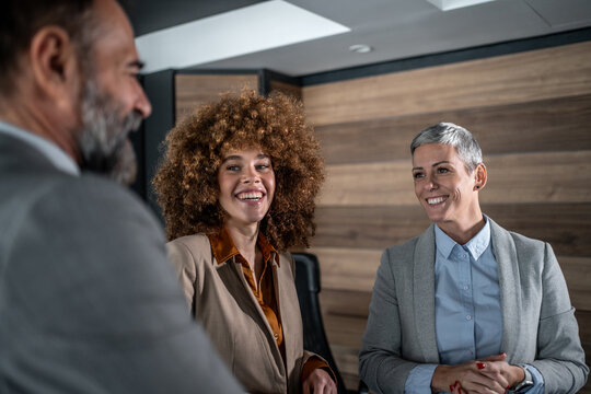 Diverse team of business professionals collaborating in office meeting - Powered by Adobe