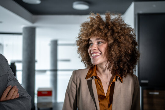 Smiling young black businesswoman in office meeting