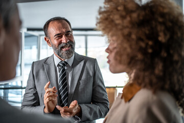 Business man having discussion with diverse colleagues in office