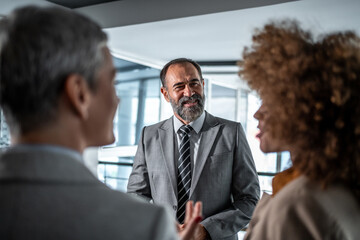 Business leader collaborating with marketing professionals in office discussion