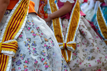 Close-up of a colourful traditional costume from the Fallas festival in Valencia with embroidered fabrics during a parade