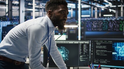 Fototapeta premium Server farm supervisor and man with disability adjust system settings based on AI analytics. Data center manager talking with technician in wheelchair overseeing automated node tree tool, camera A
