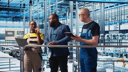 Photovoltaics smart factory quality control officer supervising system design and reliability. Industry 4.0 solar panel manufacturing plant inspector providing feedback to employees, camera A