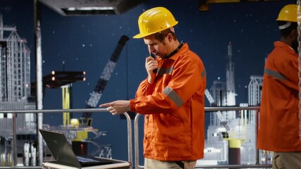 Environmental engineer uses radio communication to inspect offshore platform systems, ensuring efficient fuel production and compliance with oil and natural gas extraction. Camera A.