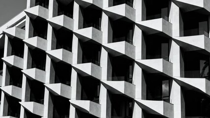 Medium shot of a geometric building exterior showcasing bold shapes sharp angles and repetitive patterns for a dynamic structural look.