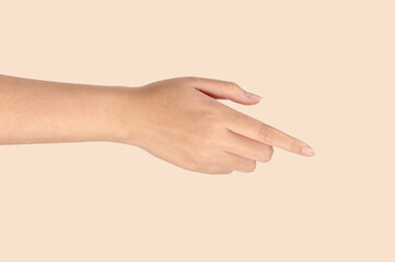 Hand of a woman gesture on light brown background.