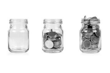 Growing saving money, Jars with different level on coin, Glass jar on coins isolated on white background.