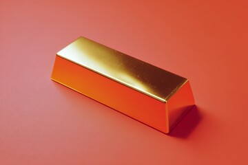 Rectangular gold bar on red surface with soft reflections.