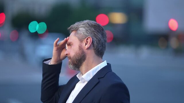 Sad man got migraine touches her head because of pain. Tired businessman has stress. Tired businessman is working overtime and has headache. Stressed man with headache. Business man with headache