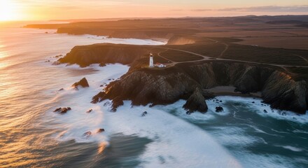 Aerial view of a majestic lighthouse standing on a rugged cliff overlooking the ocean at sunset, with waves crashing below.