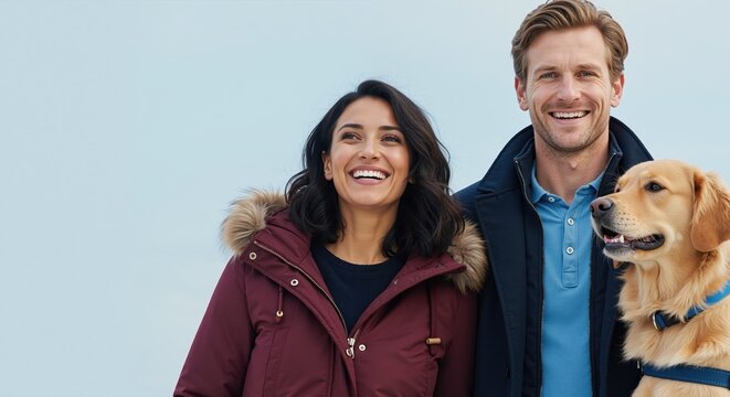 Happy young couple with their golden retriever dog smiling outdoors. Man and woman in winter jackets enjoying a walk with their pet. Lifestyle portrait with copy space - Powered by Adobe