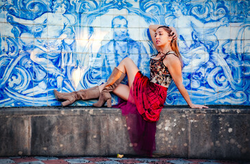 Woman posing in front of azulejos wall at Estoi Palace, Algarve, Portugal