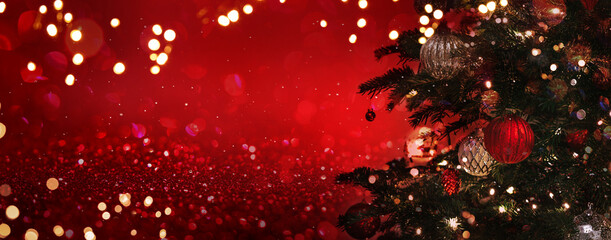Christmas tree with red and silver decorations on dark red background with bokeh, glowing. Merry Christmas and Happy New Year greeting card. Xmas and Winter holidays. Christmas wide banner