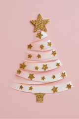 Minimalist Glitter Ribbon Christmas Tree with Golden Star on Pink Textured Background