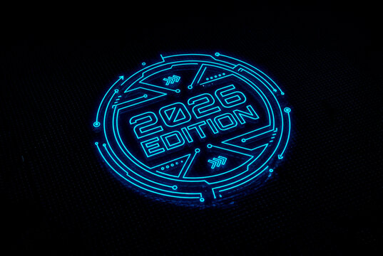 Digital Realm: Illuminated with an electric blue glow, a futuristic emblem of the year 2026. The striking circular design and modern typography exude innovation and technological advancement.