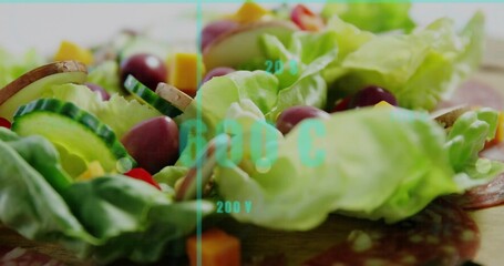 Displaying butter lettuce on wood board with cucumber dark olives cheddar salami under cyan overlay