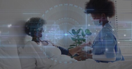 Monitoring nurse in blue scrubs checking woman in gown in bed, with cuff, stethoscope and HUD