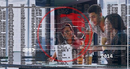 Analyzing team3 leaning over laptop and docs at table in office with HUD 2005-2014 patterned blouse