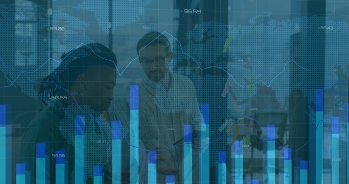 Reviewing team examining data overlay in open office, with laptop, documents in business attire