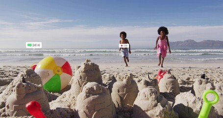 Naklejka premium Running kids in pink sundress and swim trunks racing on beach toward sandcastles with colorful ball