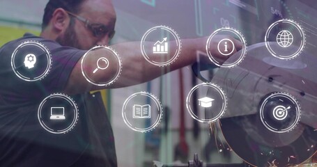 Guiding worker in dark polo, goggles, cutting metal at grinder at shop with HUD-icons and sparks