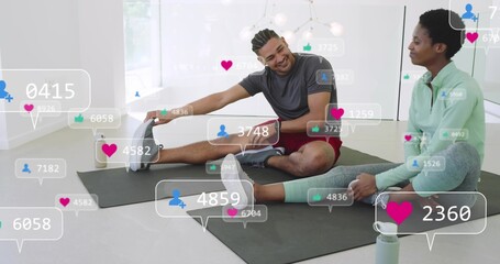Stretching partners in athletic clothes reaching feet on dark mats in studio with overlay bubbles