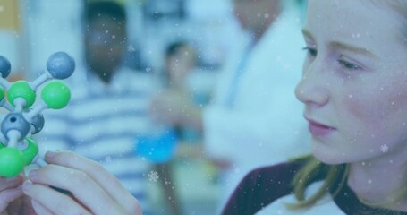 Studying teen wearing dark collar holding molecular model in lab with teacher lab coat, copy space