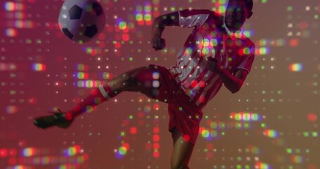 Kicking adult player doing high side kick in studio with pixel lights, striped kit, soccer ball